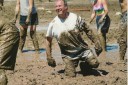 Dr Calhoun having some fun playing mud volleyball.
